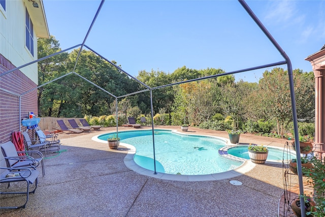 view of pool with a lanai and a patio area