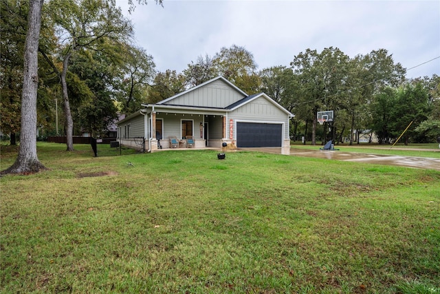 view of front of property with a front yard, a porch, and a garage