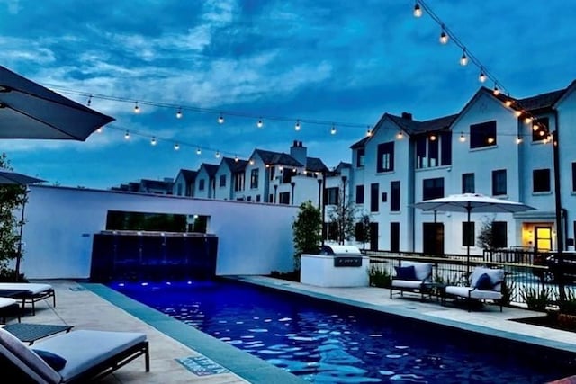 view of swimming pool featuring a patio and area for grilling