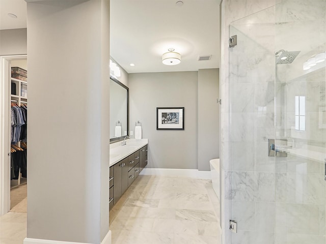 bathroom featuring vanity and a shower with shower door