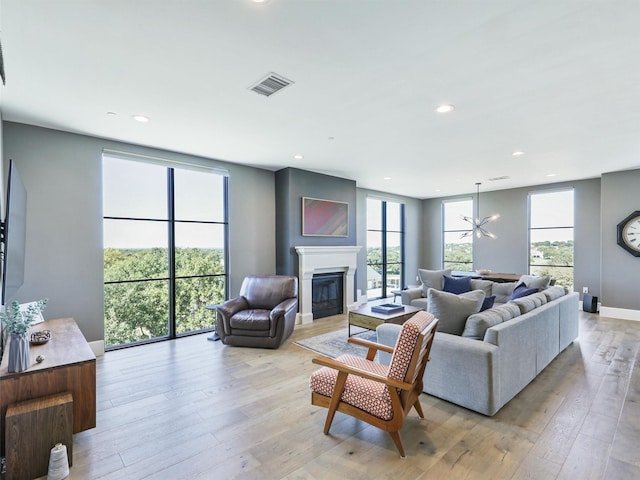 living room featuring light hardwood / wood-style floors and an inviting chandelier