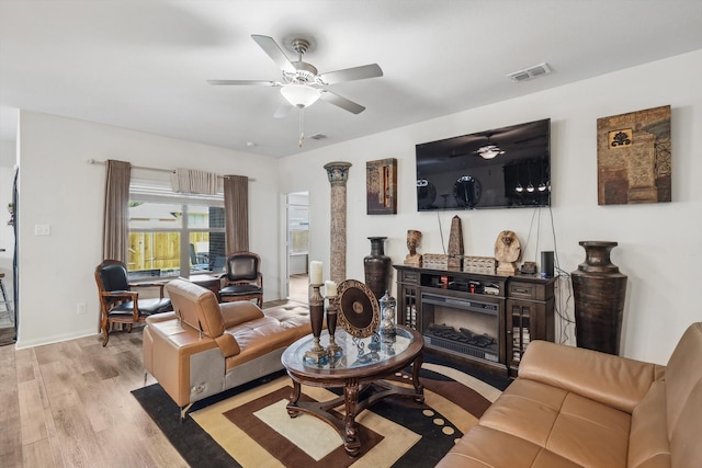 living room featuring light wood-type flooring and ceiling fan