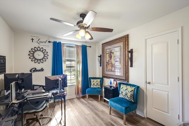 home office with ceiling fan and light hardwood / wood-style floors