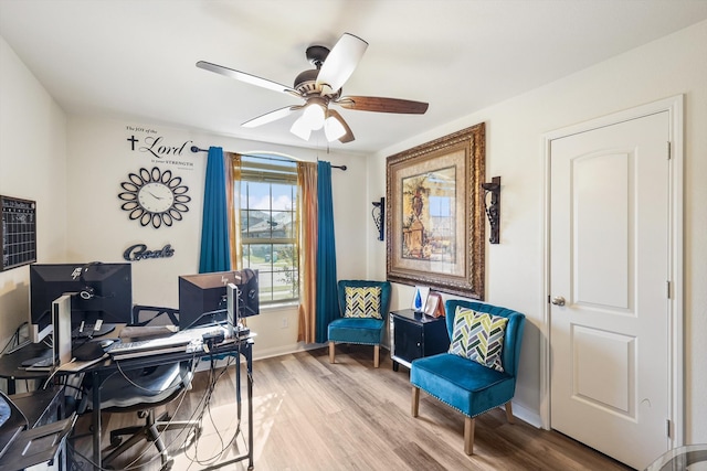 home office with wood-type flooring and ceiling fan