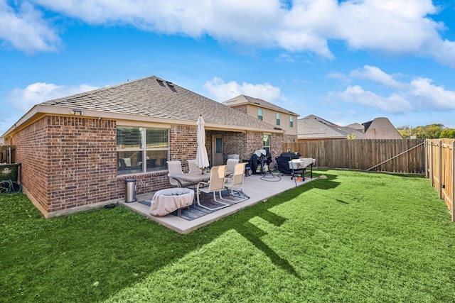 back of property with a lawn and a patio area