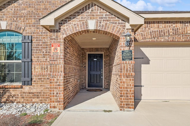 doorway to property with a garage