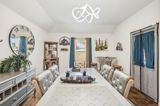 dining room featuring dark hardwood / wood-style flooring and vaulted ceiling