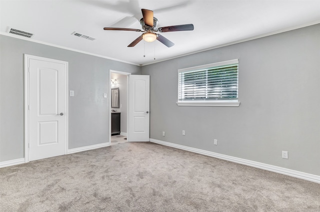 unfurnished bedroom with ensuite bathroom, light carpet, ceiling fan, and crown molding