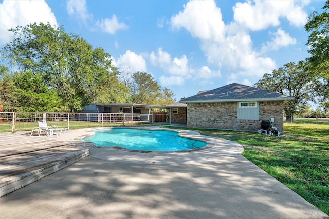 view of pool featuring a yard and a patio area