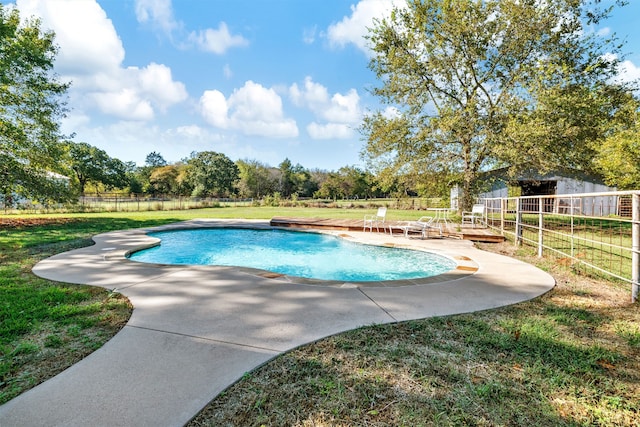 view of pool with a lawn and a patio area