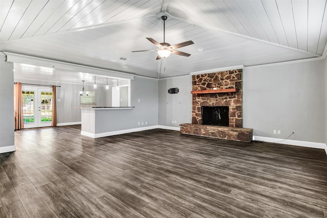 unfurnished living room featuring dark hardwood / wood-style flooring, wood ceiling, ceiling fan, and a stone fireplace