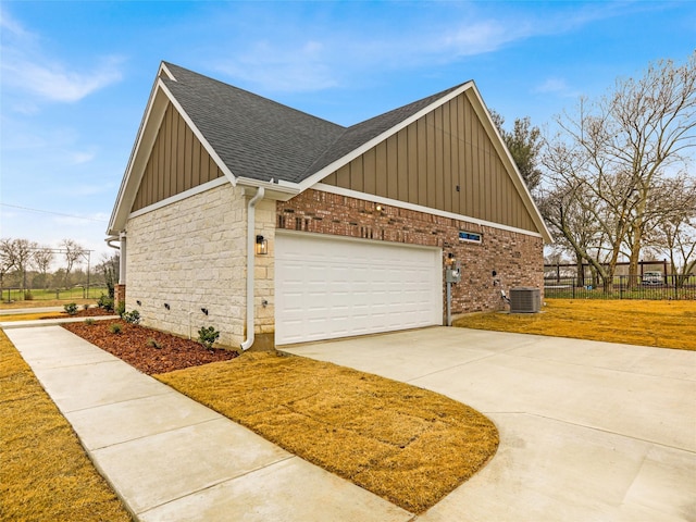 view of side of home featuring a garage and central air condition unit