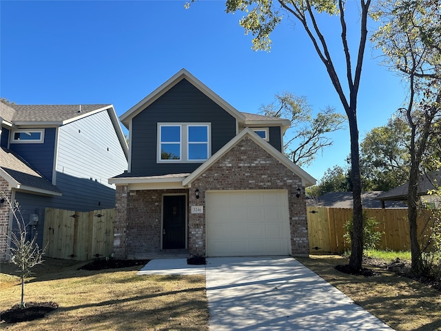 view of front of home featuring a front lawn and a garage