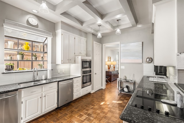 kitchen with sink, appliances with stainless steel finishes, coffered ceiling, dark parquet floors, and white cabinets