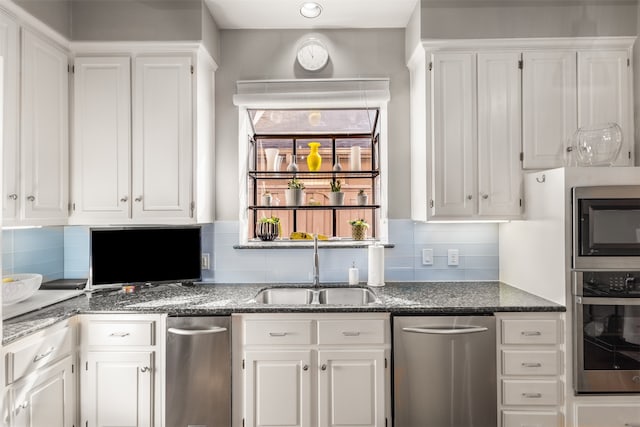 kitchen featuring white cabinetry, sink, tasteful backsplash, and appliances with stainless steel finishes