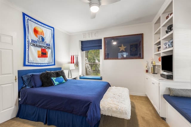 carpeted bedroom featuring crown molding and ceiling fan