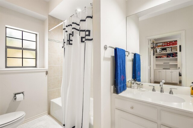 full bathroom featuring vanity, shower / tub combo, and toilet