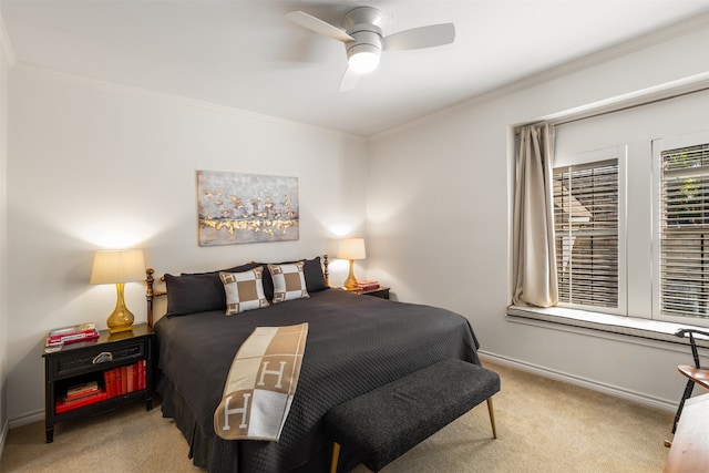 carpeted bedroom with ornamental molding and ceiling fan