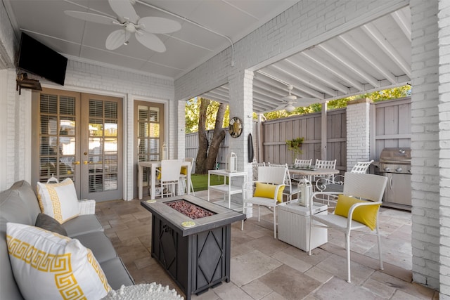 view of patio with an outdoor living space with a fire pit and ceiling fan