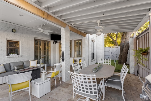 view of patio / terrace featuring an outdoor living space with a fire pit and ceiling fan