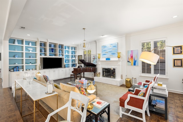 living room with crown molding, built in features, a premium fireplace, and dark parquet floors