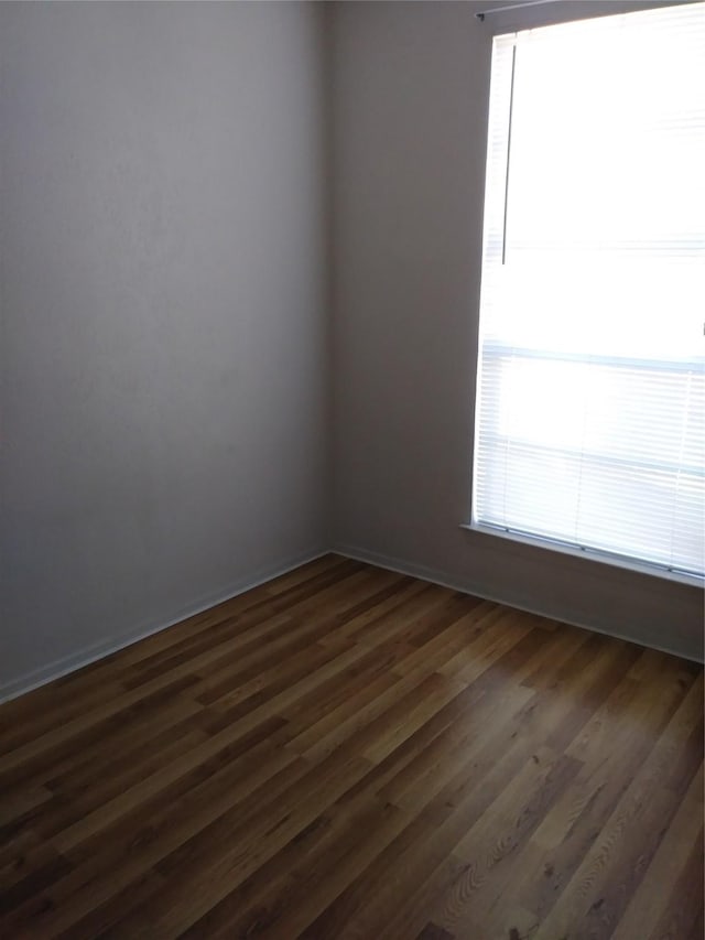 spare room featuring dark hardwood / wood-style flooring