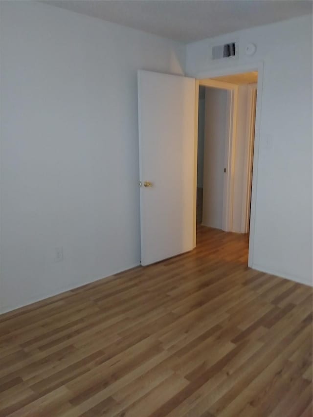 spare room featuring hardwood / wood-style floors