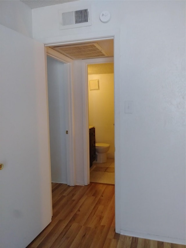 corridor featuring hardwood / wood-style floors