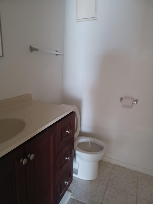 bathroom with vanity, tile patterned floors, and toilet