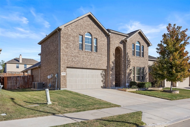 front facade with a front yard, a garage, and cooling unit