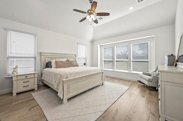 bedroom with light hardwood / wood-style flooring, lofted ceiling, multiple windows, and ceiling fan