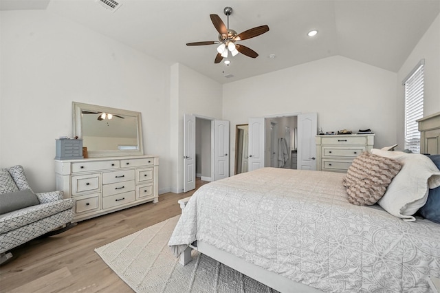 bedroom with light wood-type flooring, ceiling fan, and high vaulted ceiling