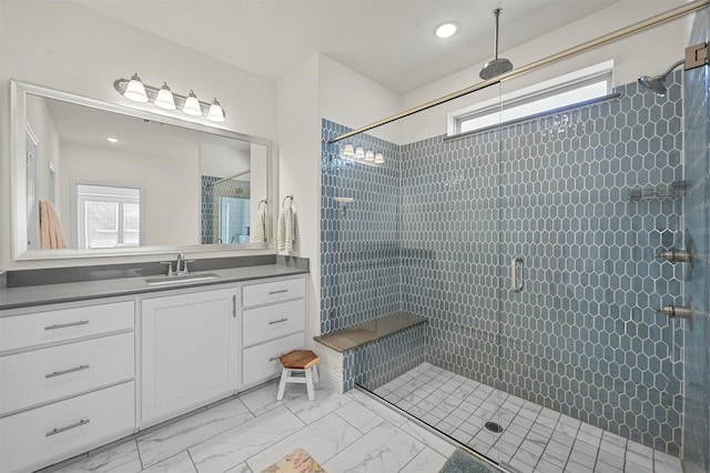 bathroom featuring vanity and a shower with shower door