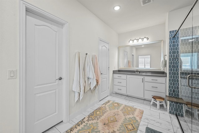 bathroom with walk in shower and vanity