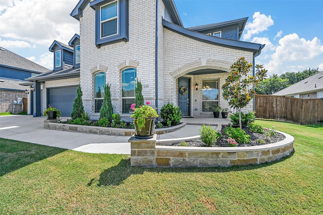 view of front of property featuring a garage and a front yard