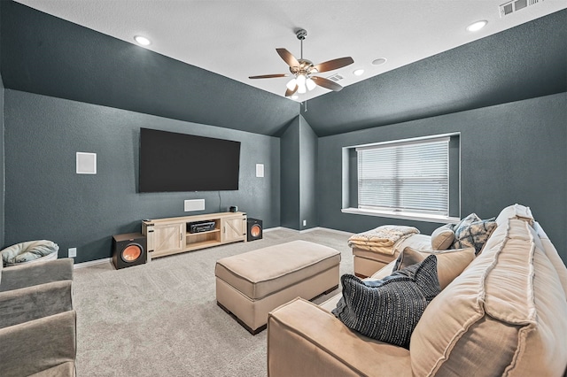 living room featuring vaulted ceiling, carpet flooring, ceiling fan, and a textured ceiling