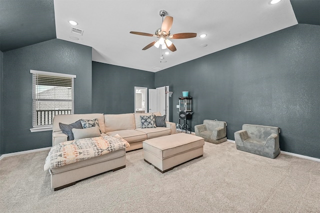 living room featuring light colored carpet, lofted ceiling, and ceiling fan