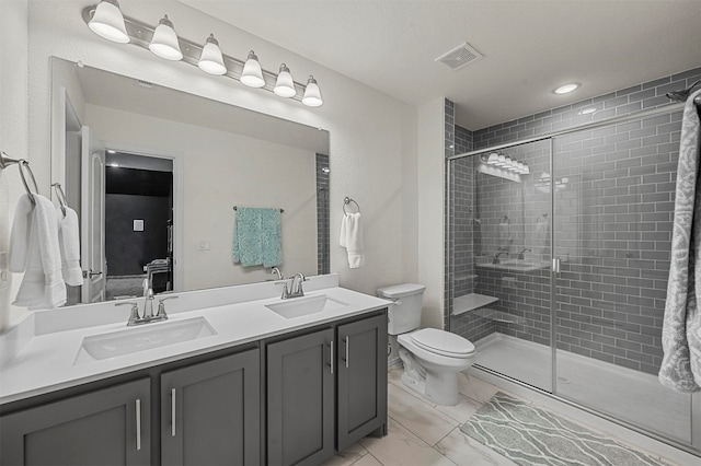 bathroom with vanity, toilet, and an enclosed shower