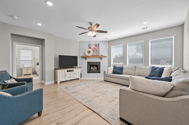 living room featuring light wood-type flooring and ceiling fan