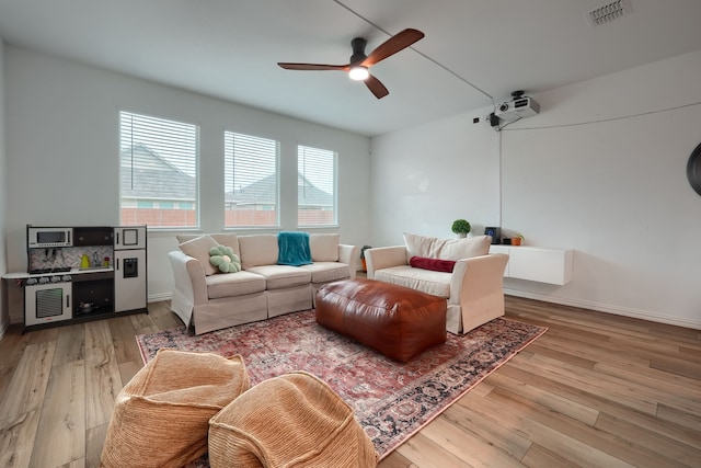 living room with ceiling fan and light wood-type flooring