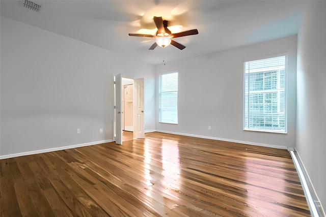 empty room with hardwood / wood-style flooring and ceiling fan