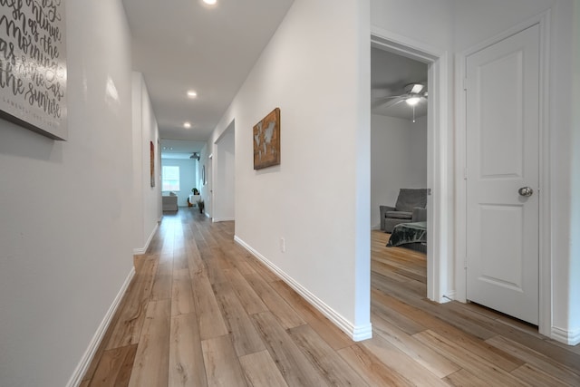 hallway with light hardwood / wood-style floors