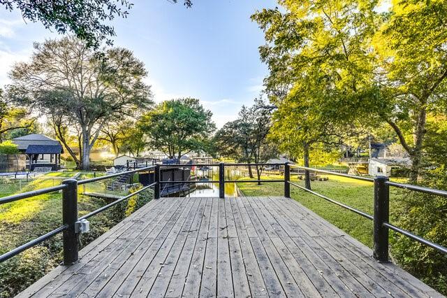 wooden terrace with a lawn