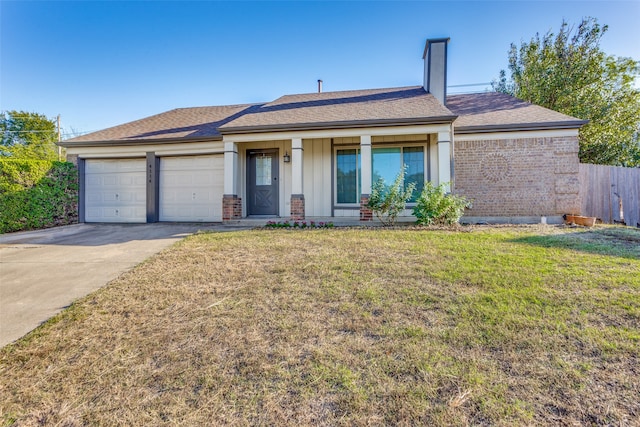 ranch-style house featuring a garage and a front lawn