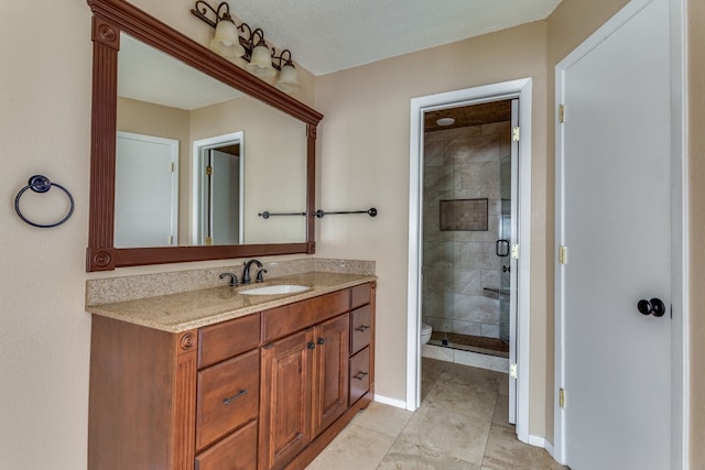 bathroom featuring an enclosed shower, vanity, tile patterned flooring, and toilet