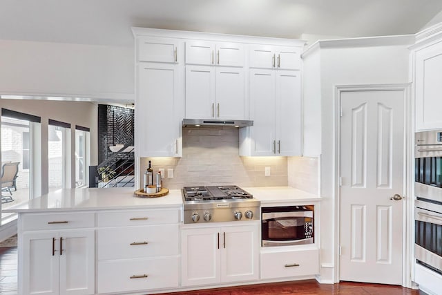 kitchen featuring tasteful backsplash, appliances with stainless steel finishes, and white cabinets