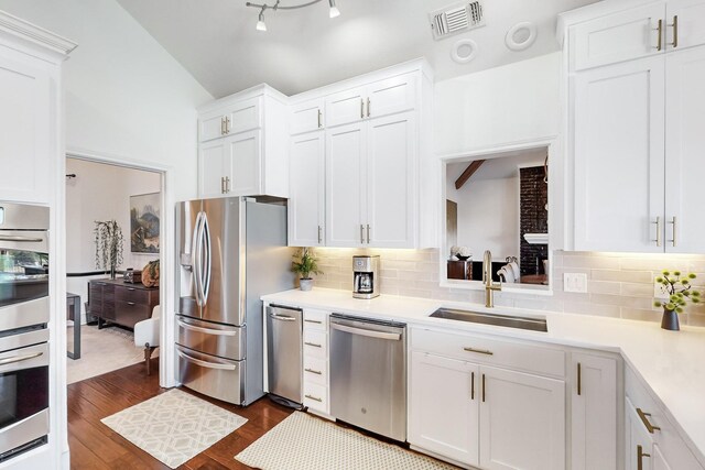 kitchen featuring sink, white cabinets, dark wood-type flooring, and appliances with stainless steel finishes