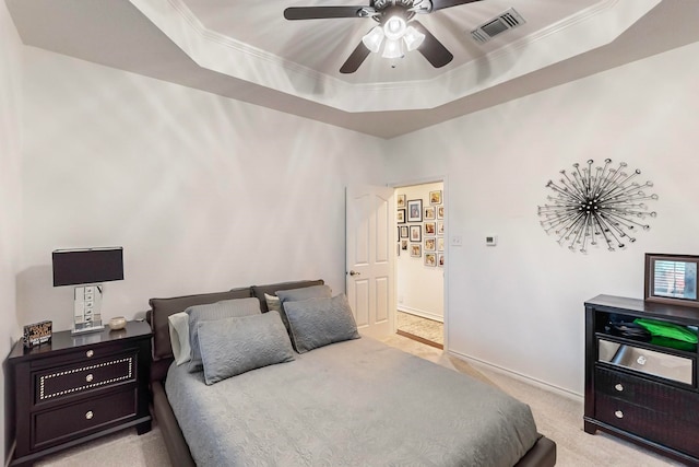 carpeted bedroom with crown molding, a raised ceiling, and ceiling fan