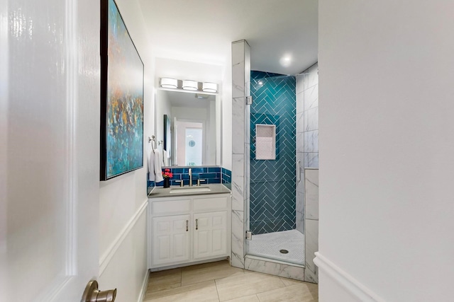 bathroom featuring walk in shower, vanity, and tile patterned flooring