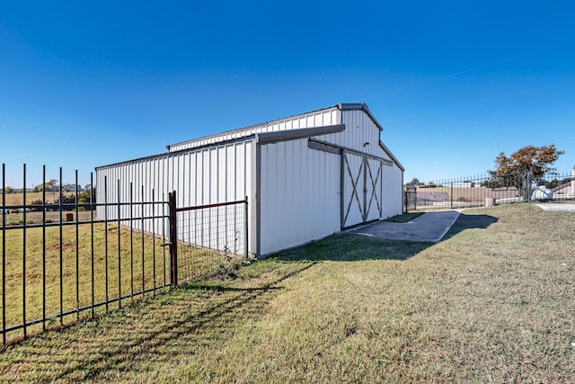 view of outbuilding with a yard